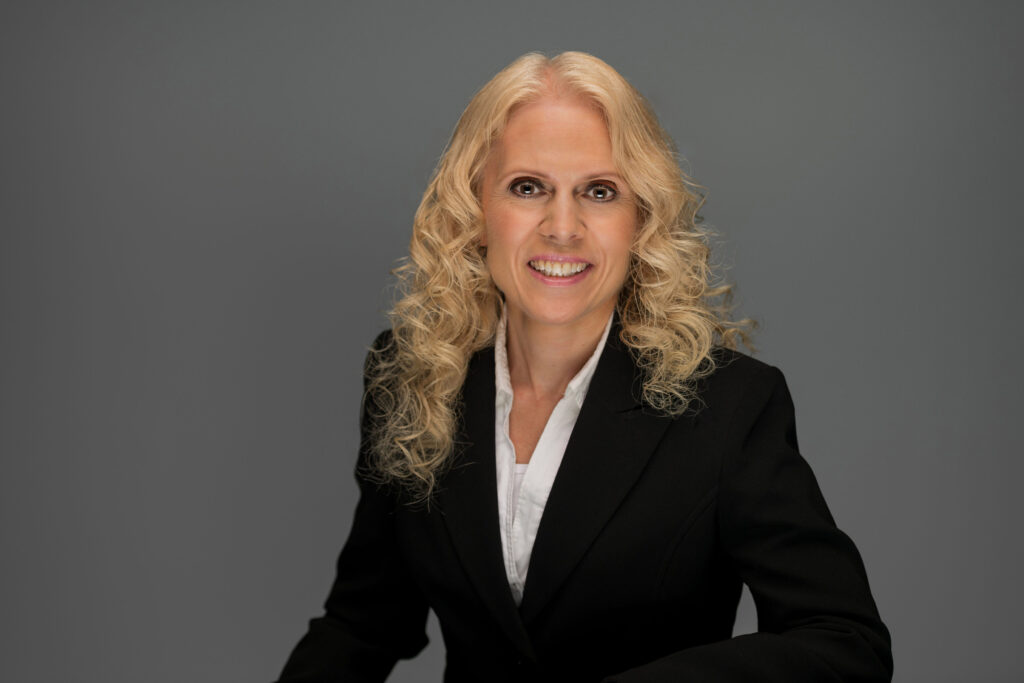 Kristen Bauman, female therapist and counsellor at Oakville Wellness Center, smiling in professional headshot